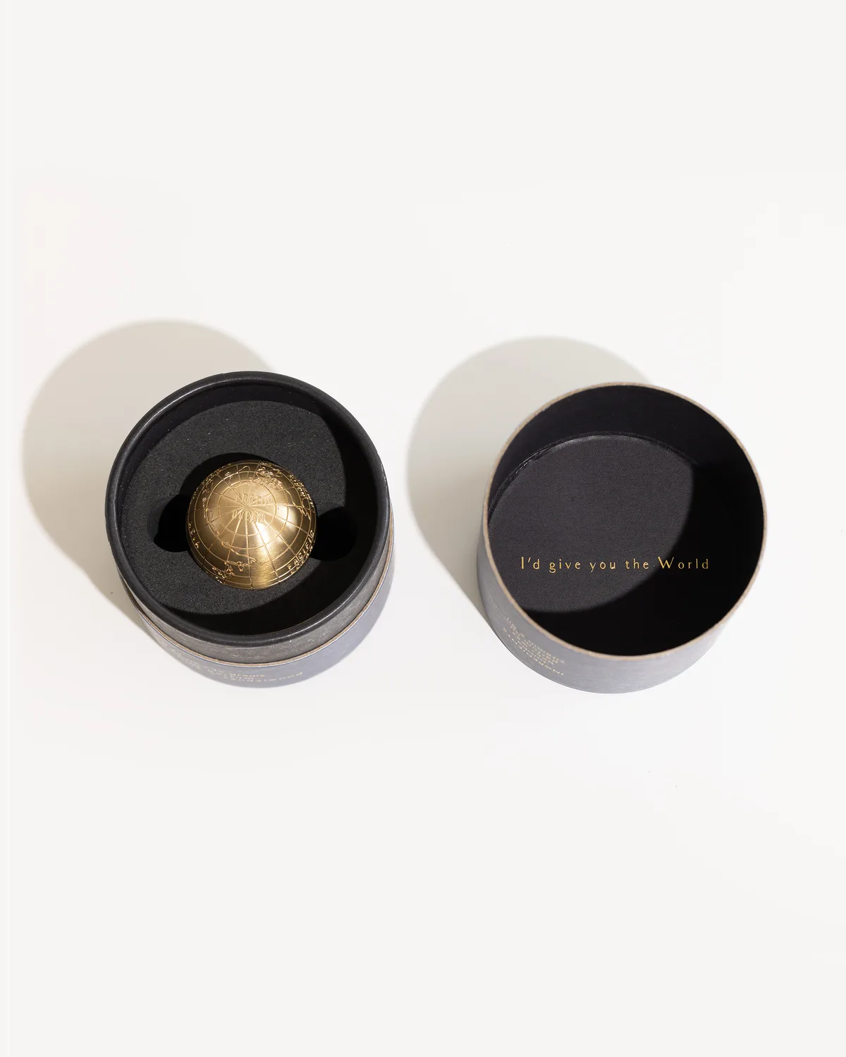 "I'd give you the World" printed in gold inside the lid of the signature canister